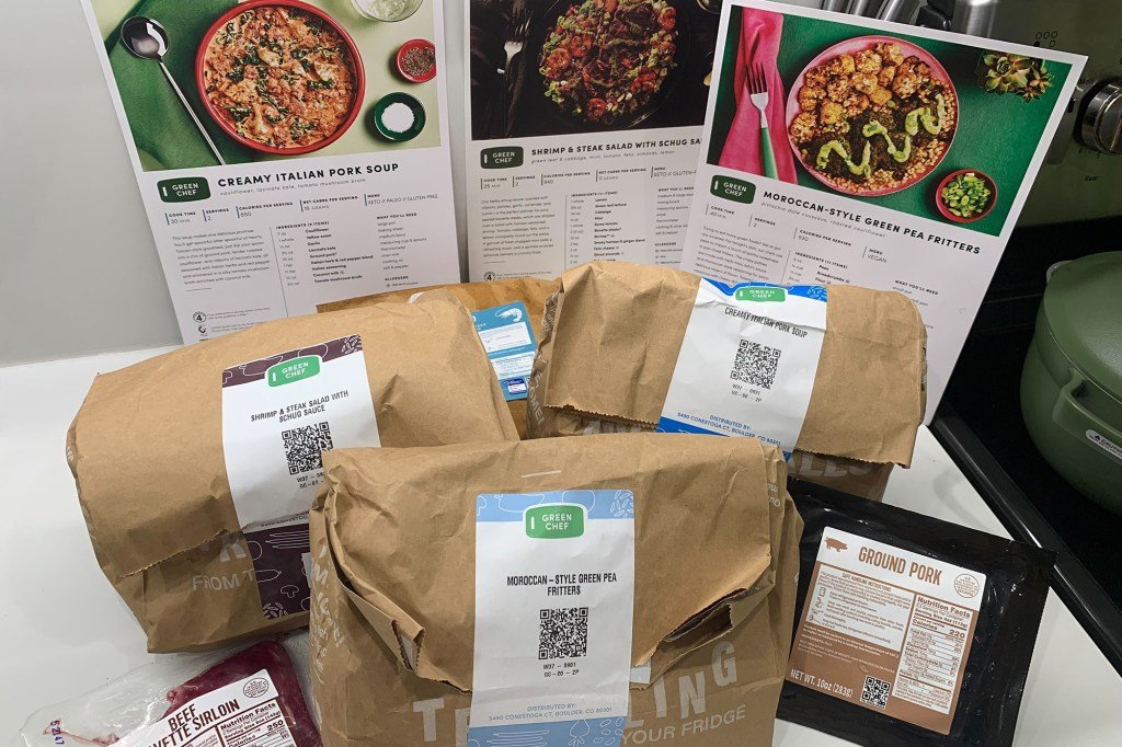 Three green chef meals and recipe cards on a counter
